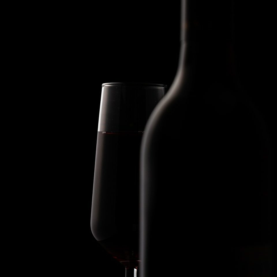 wine glass behind bottle
