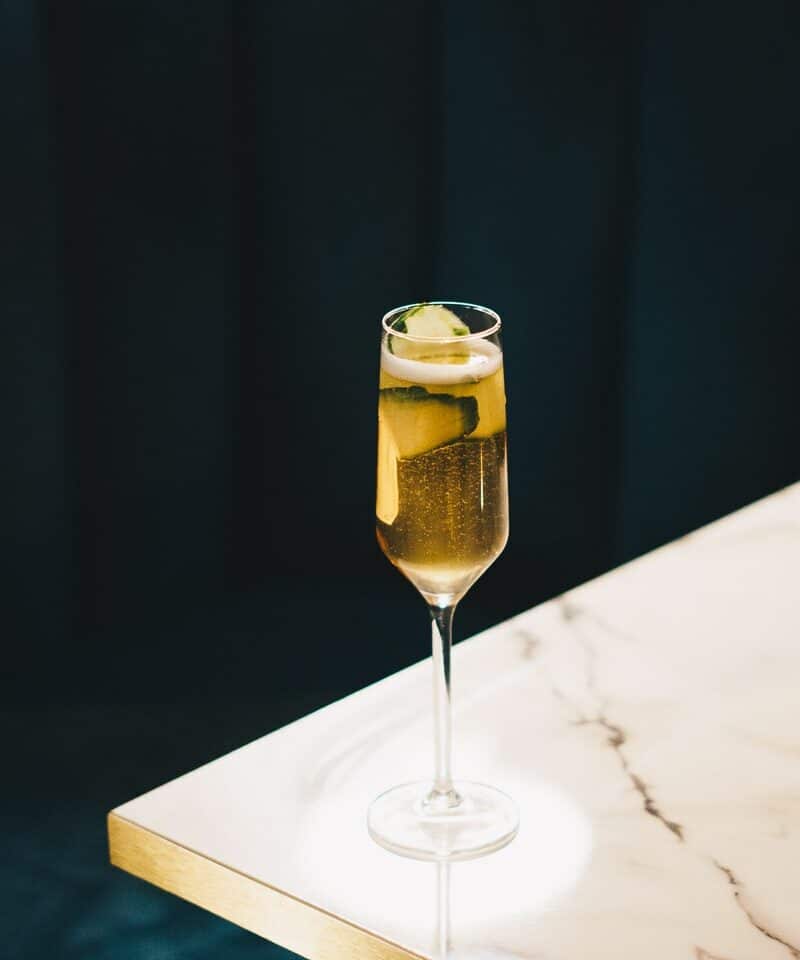 clear wine glass with yellow liquid