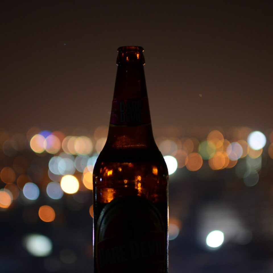 shallow focus photo of brown glass bottle